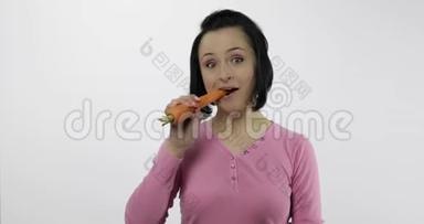 年轻的女人吃胡萝卜说。 女孩先咬一口然后说想咬